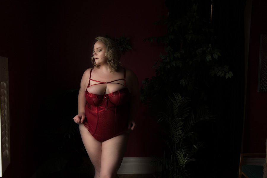 plus size woman in red lingering overcoming body shaming